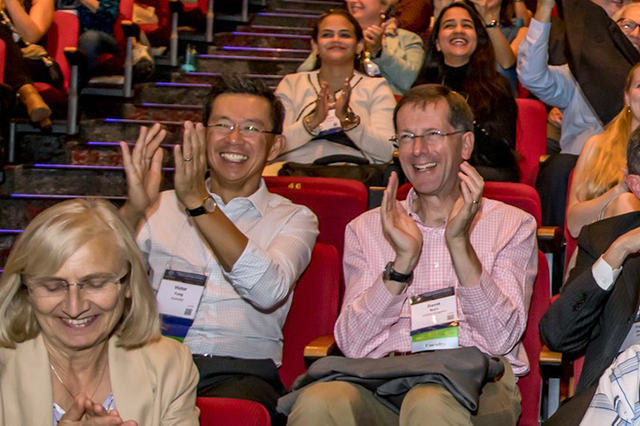 A crowd of delegates from around the globe clap at the International Congress.